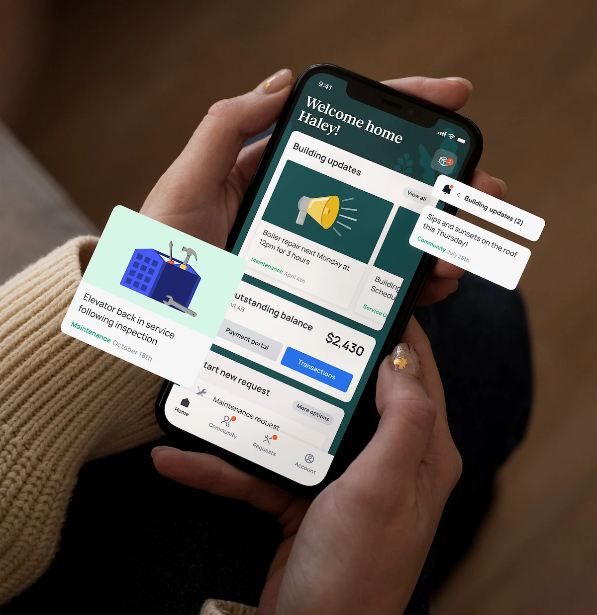 Hands holding phone showing a home app with building updates, maintenance alerts, and balance information.