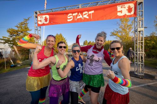 a group of women pose for a picture as they wait to run a race