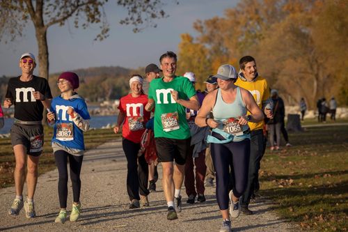 a group of people running toward the finish line