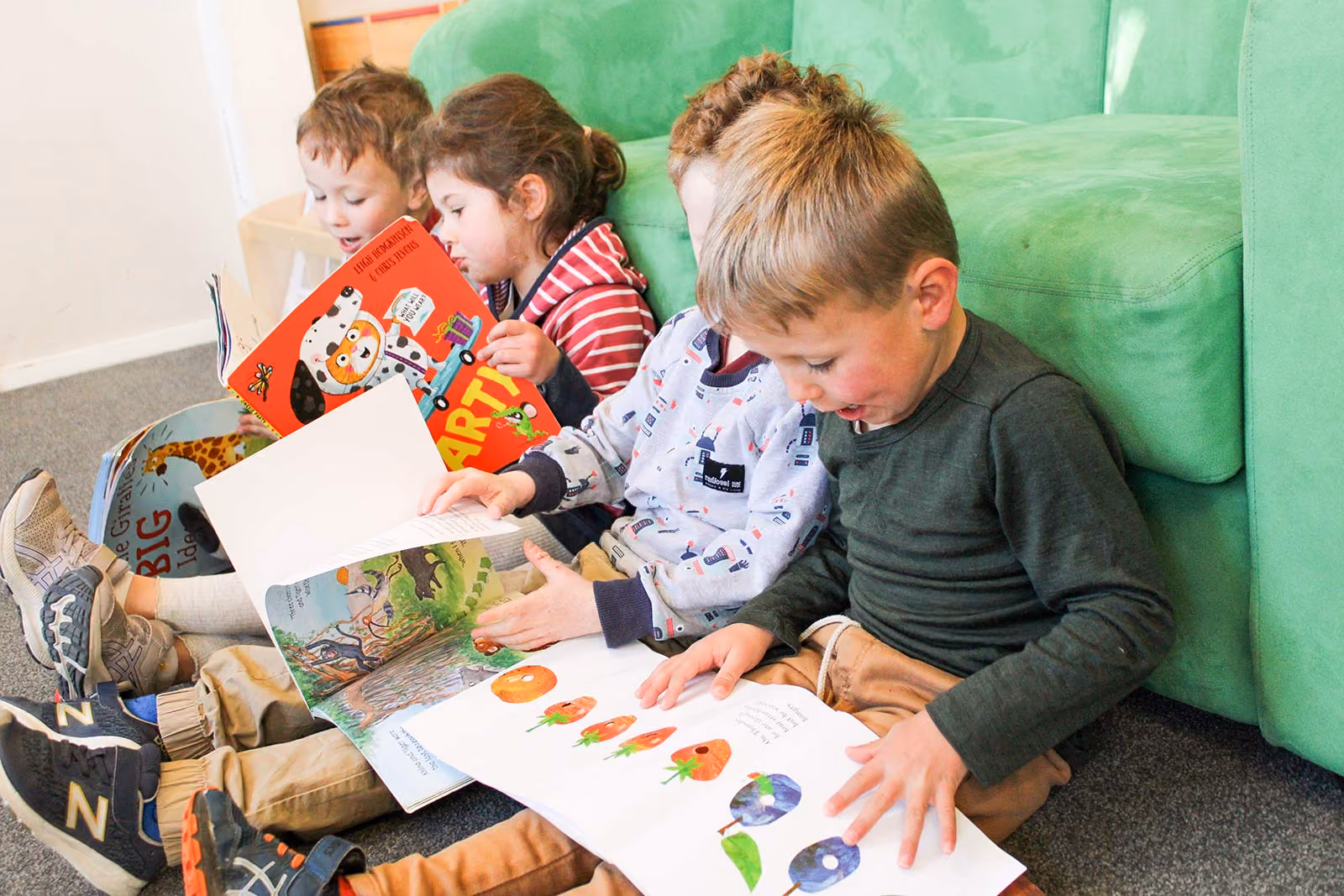 Kids sitting and reading books,