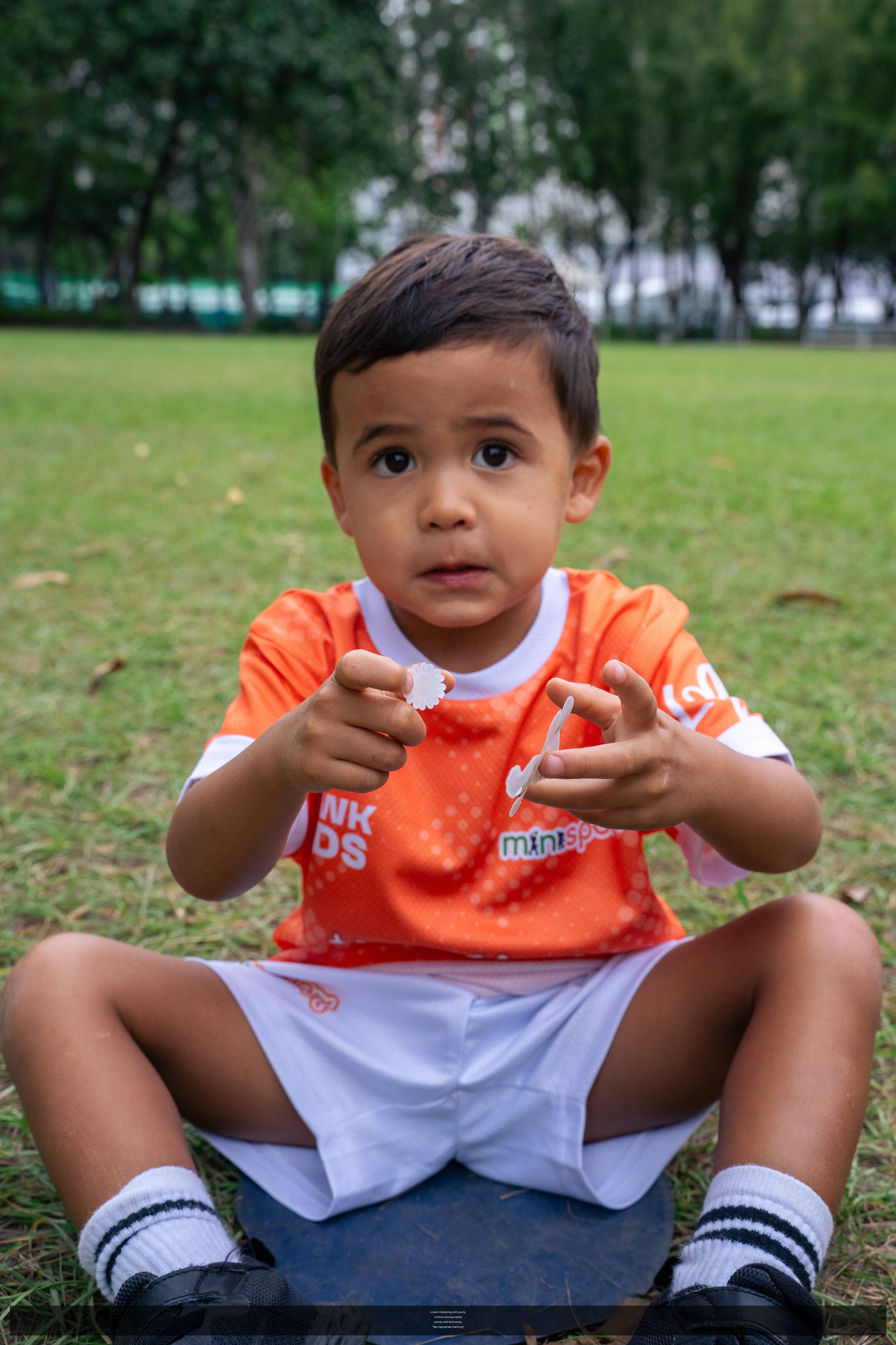 a coach interacting with young children during a sports activity, with text overlay