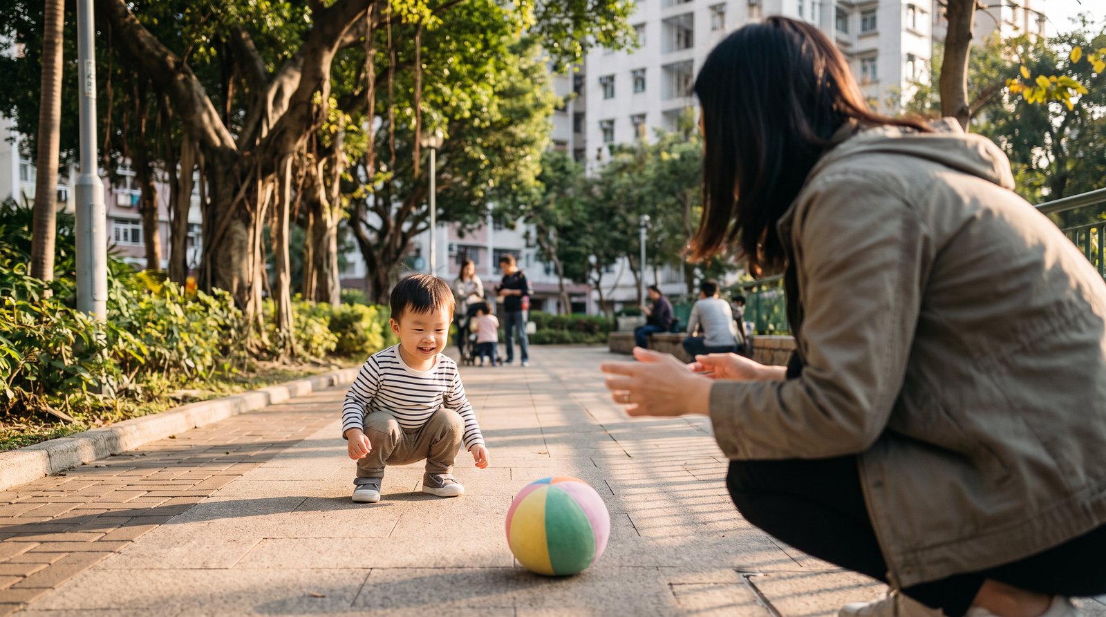 Parent positioned in front of a toddler during catching practice