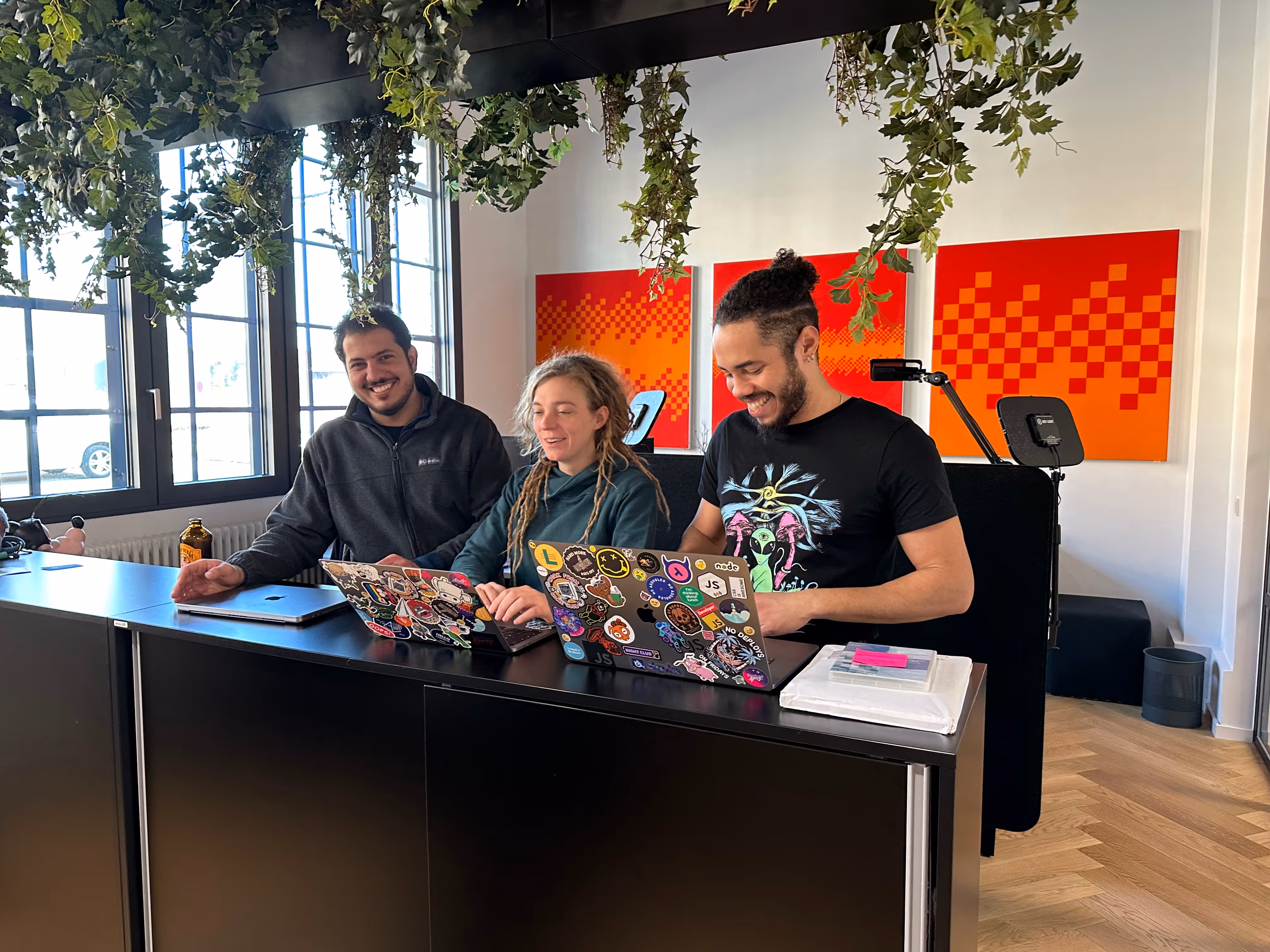 Three foobarista smiling while they were interrupted in their work ;-)