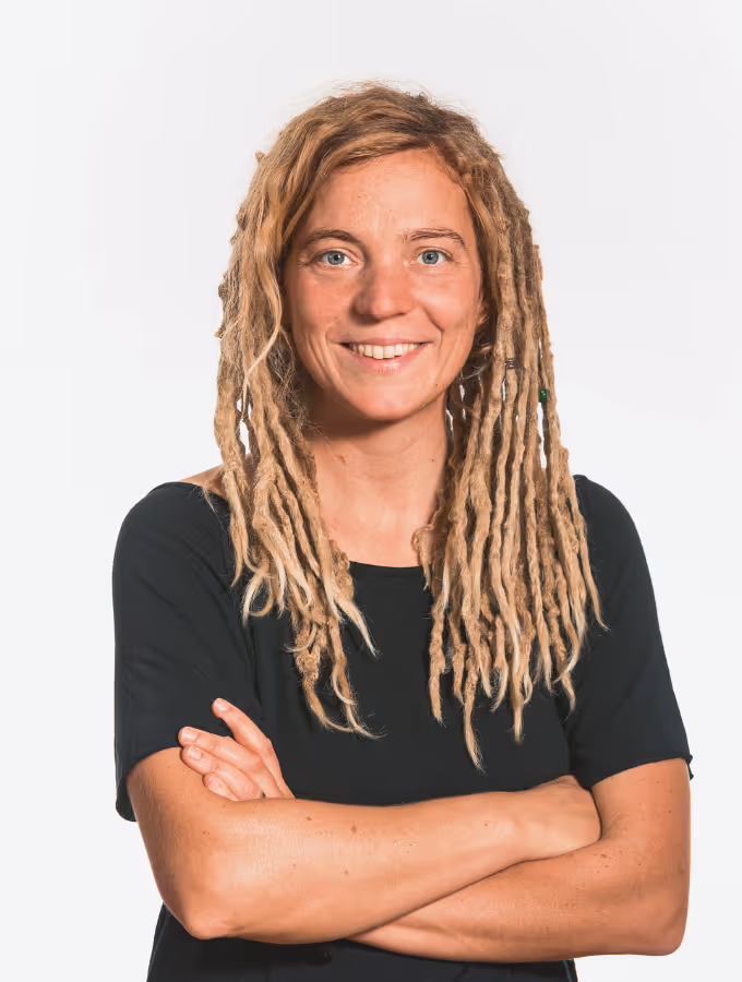 Showing a profile picture of the person to reach out in case of any questions. Female person, looking straight in the camera, smiling.