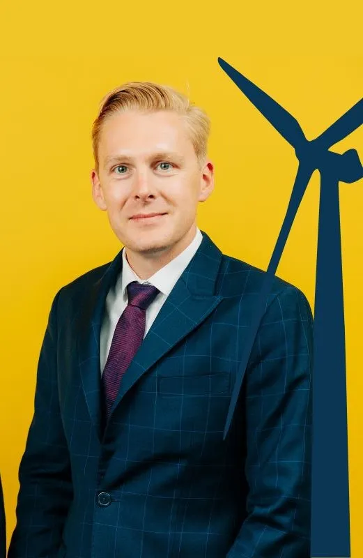 man in suit in front of yellow background
