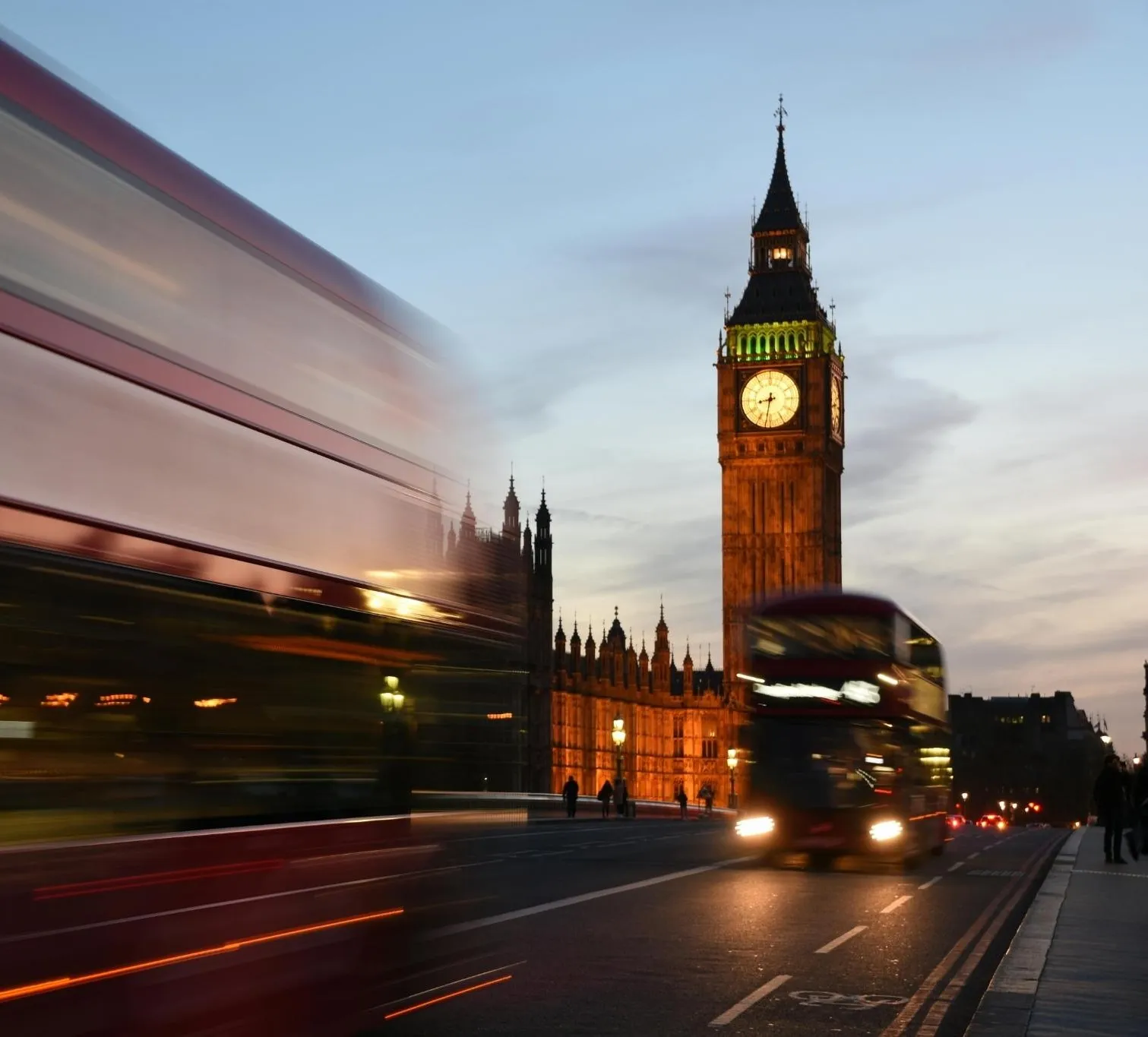 man in suit with a red briefcase in front of light blue background