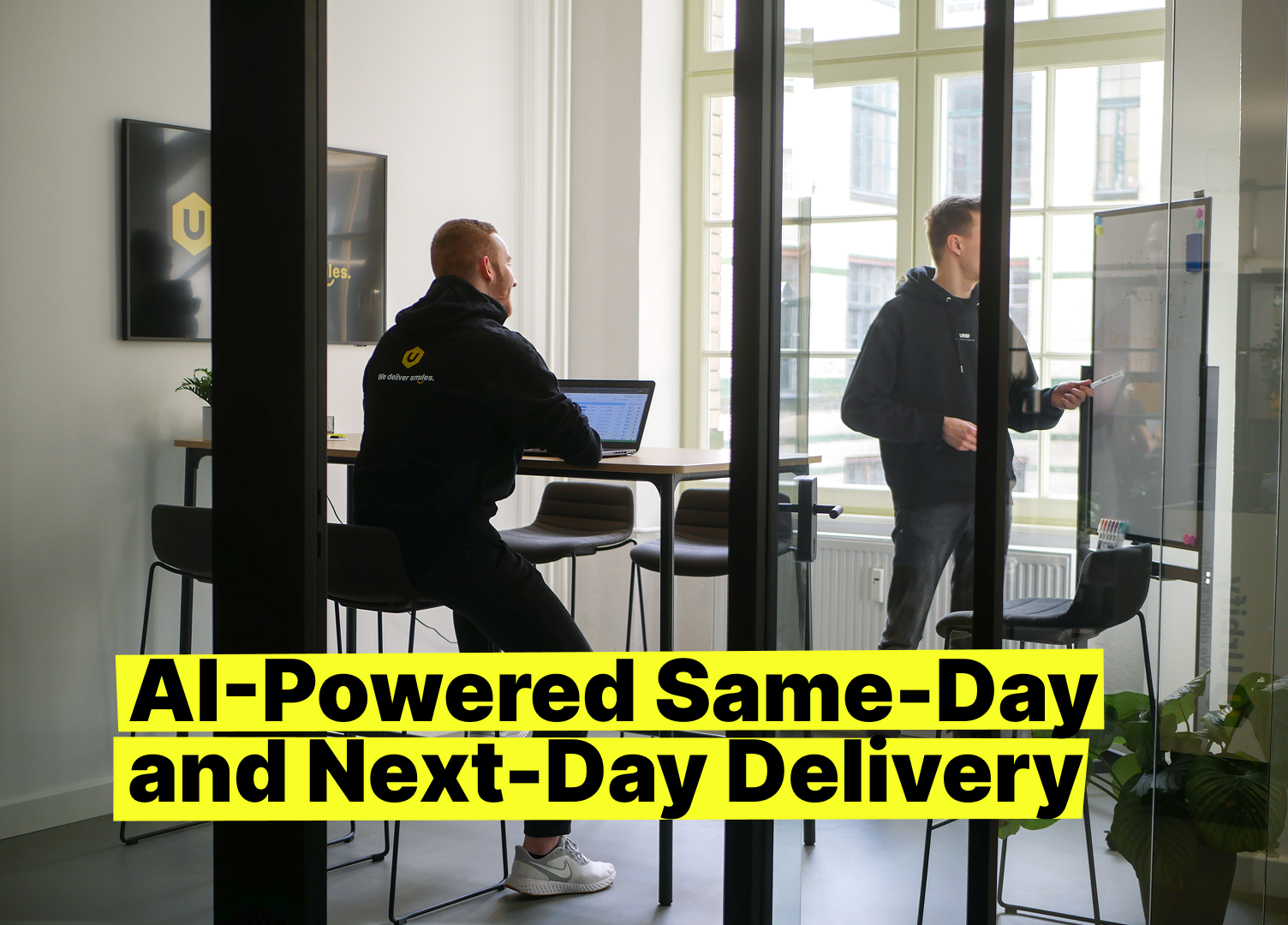Urbify logistics team reviewing AI-powered same- and next-day delivery planning in a bright office