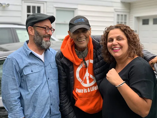 Members of The Action Lab board smiling with the musician Harry Belafonte