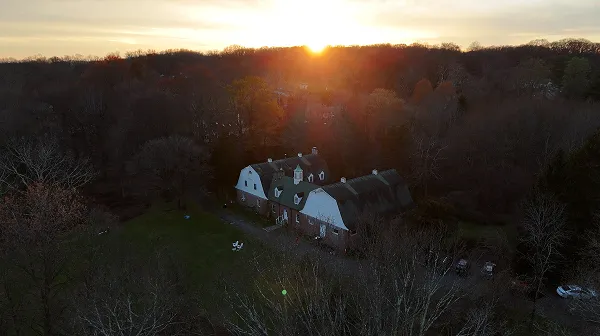 Aerial view of woods surrounding the Action Lab's property at sunset