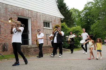 A second-line of musicians playing brass instruments