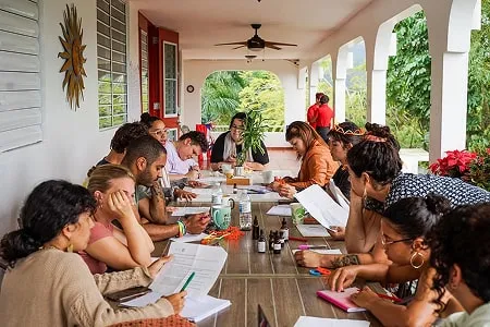 A diverse group of people having a planning meeting around a long table in Puerto Rico