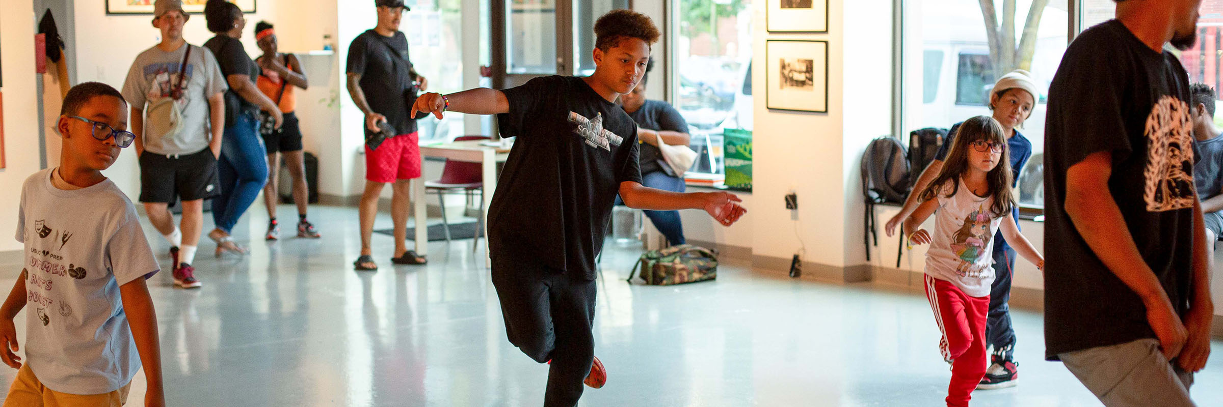 A group of young people following along learning dance moves