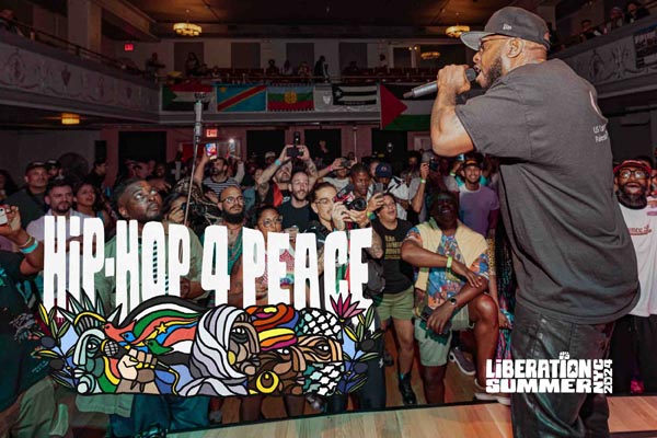 Rapper performing for an energetic crowd at a Hip-Hop 4 Peace event