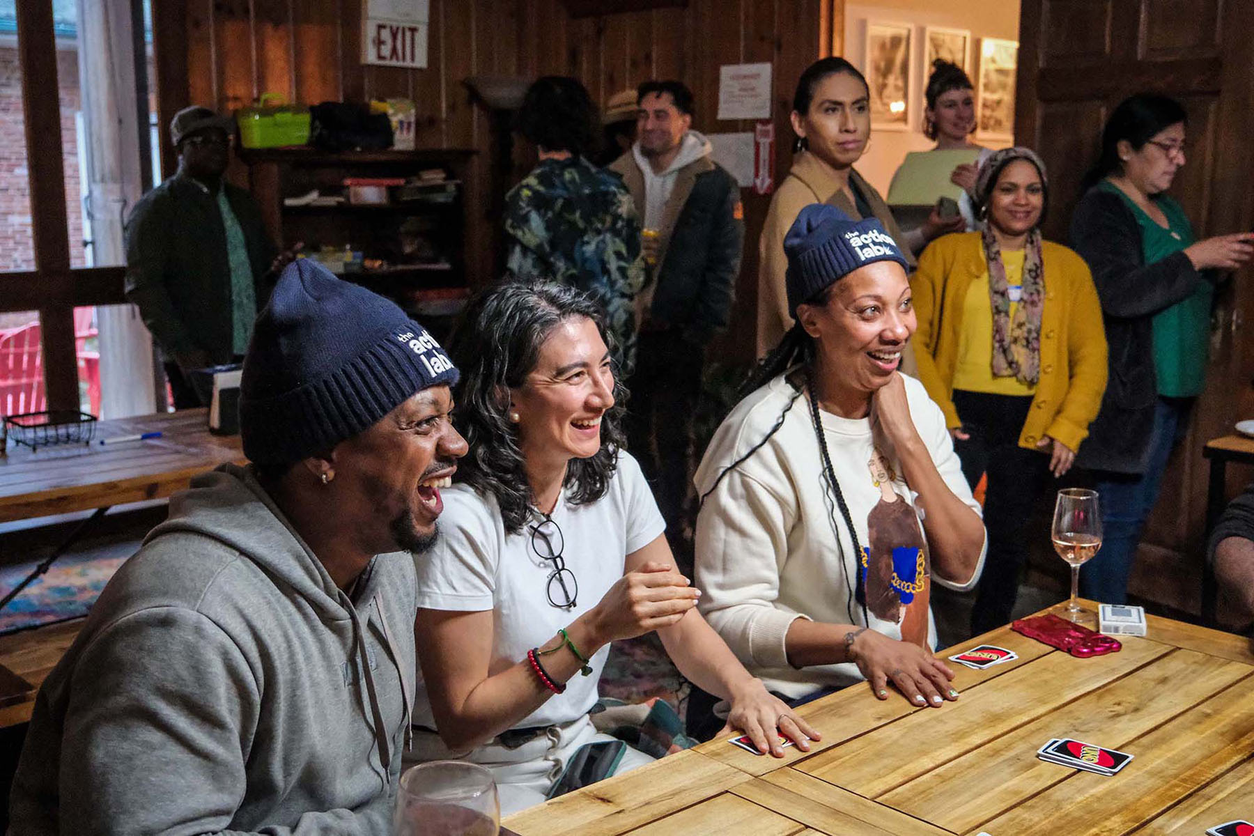 Group of people sitting around a table laughing.