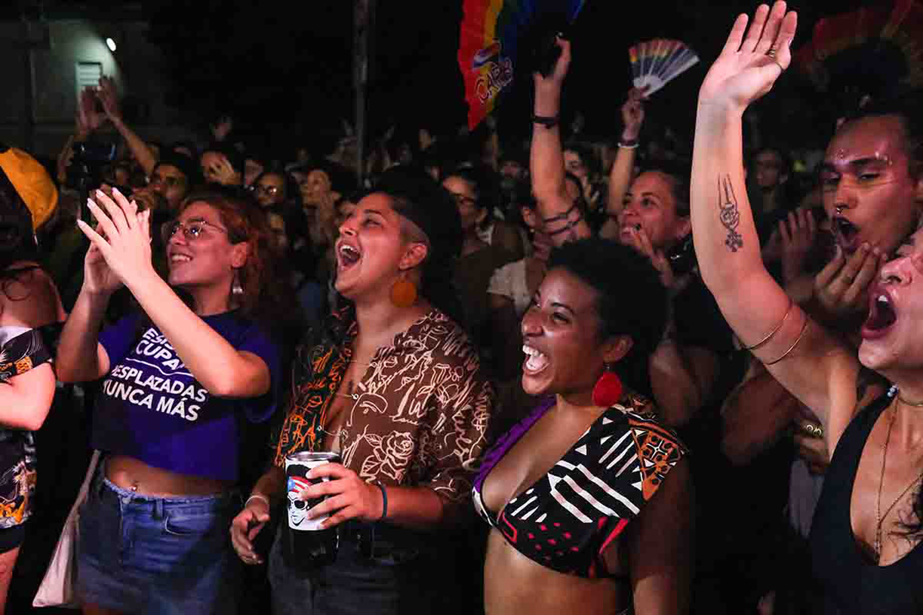 Cheering crowd celebrates at a lively nighttime event.