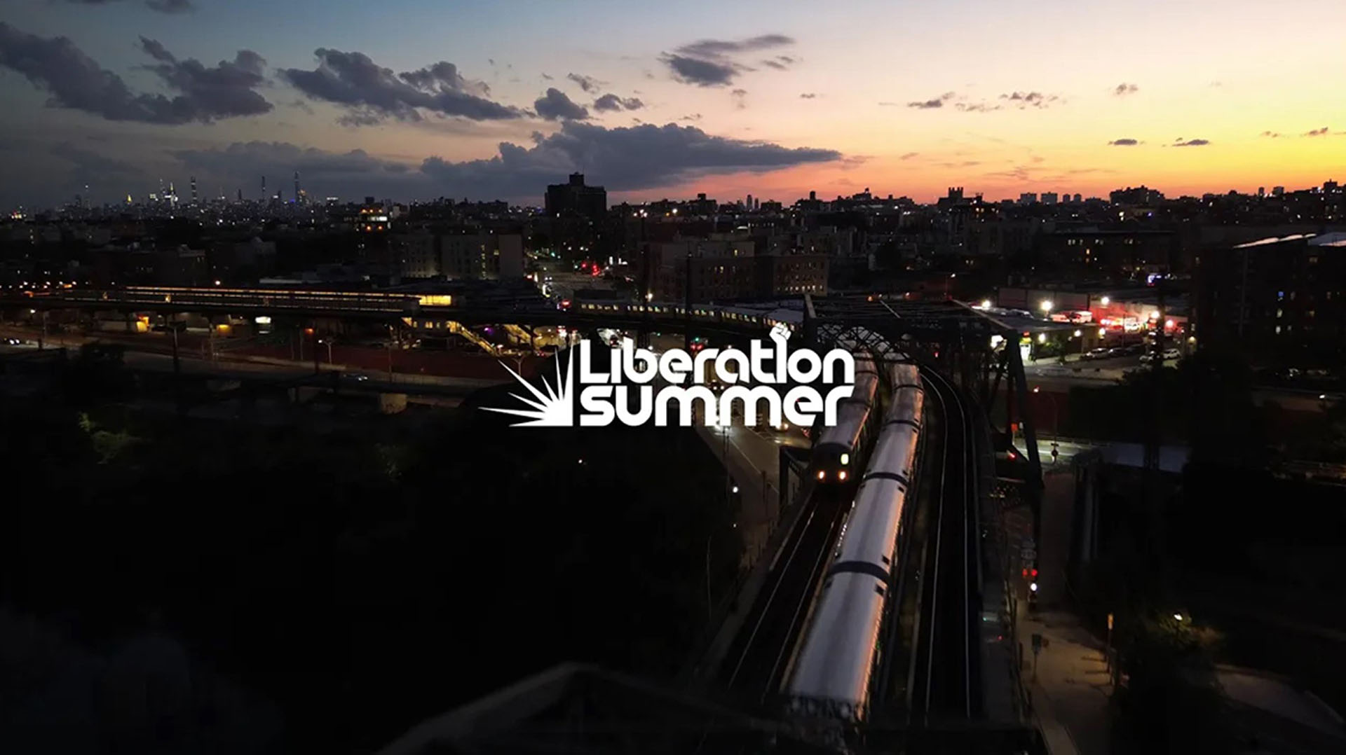 Sunset view of a city skyline and elevated train tracks with “Liberation Summer” overlaid.