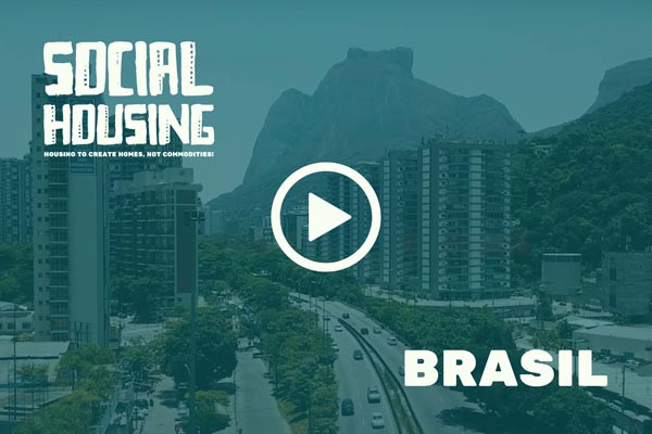 Cityscape in Brazil with high-rise housing and mountains behind a “Social Housing” video overlay