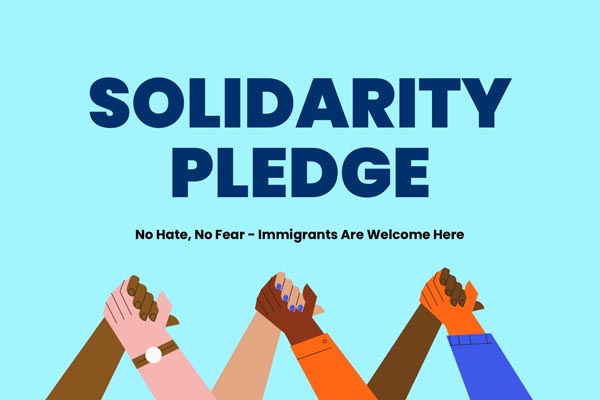 Graphic shows raised hands of different skin tones beneath the text “Solidarity Pledge.”
