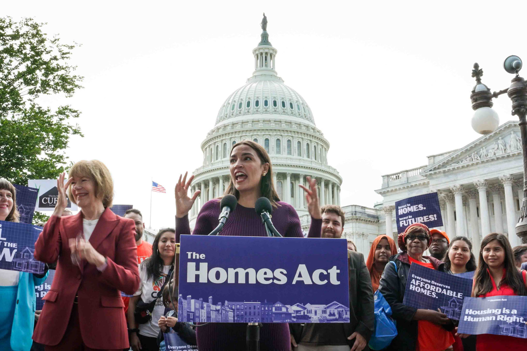 Alexandria Ocasio-Cortez addresses a crowd at a Homes Act rally in front of the U.S. Capitol.