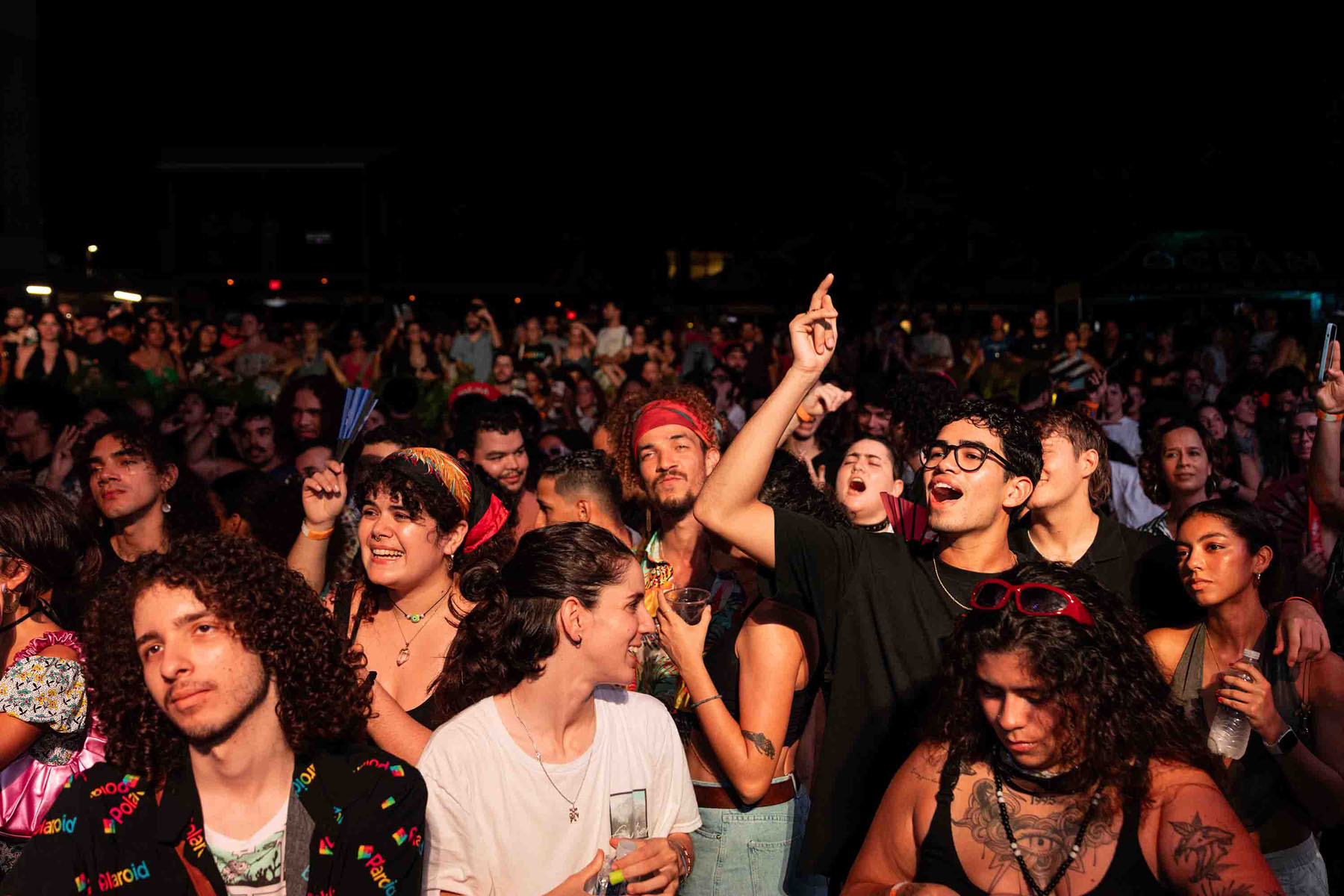 Crowd enjoys a lively outdoor concert at night.