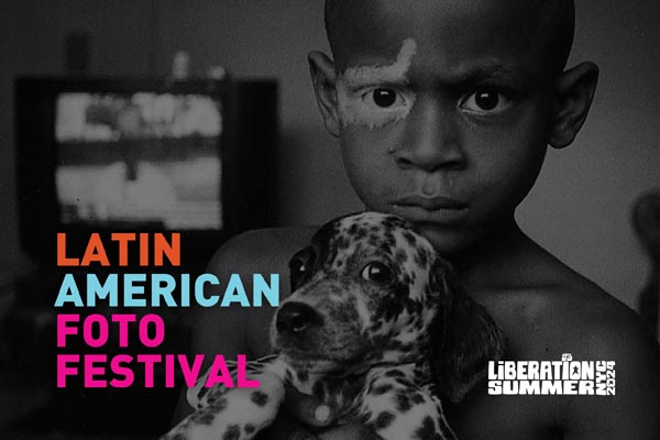 Black-and-white photo of a child holding a spotted puppy for the Latin American Foto Festival.
