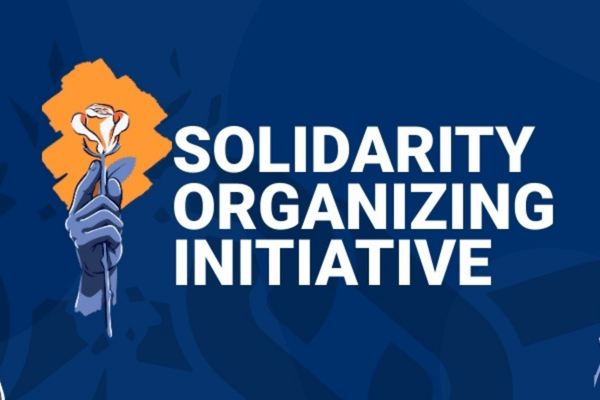 Blue background, with Solidarity Organizing Initiative in white lettering and a hand holding an orange rose.