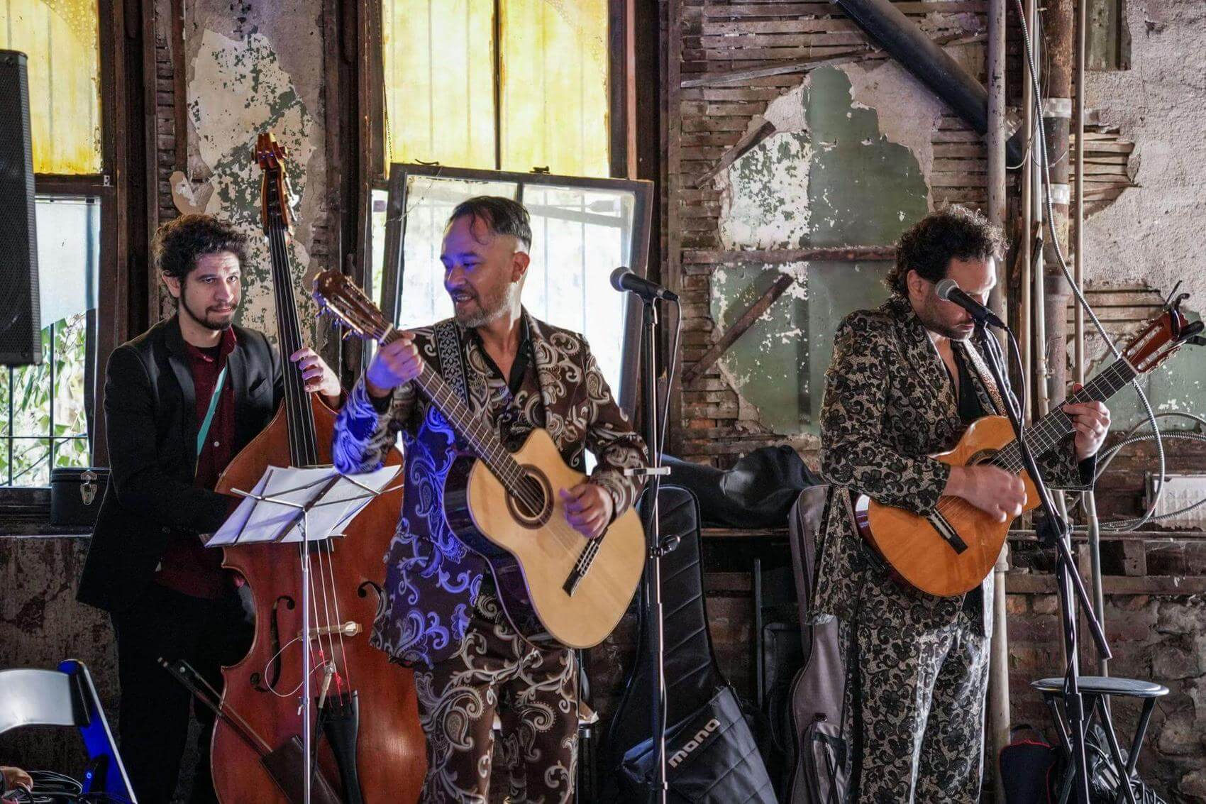 Artist painting portraits of two people in a raw building space.