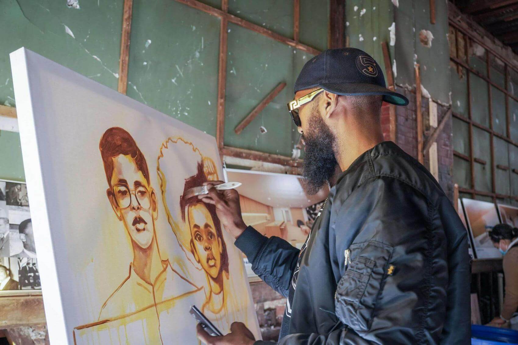 Two women in conversation, with architectural rendering posters on display.