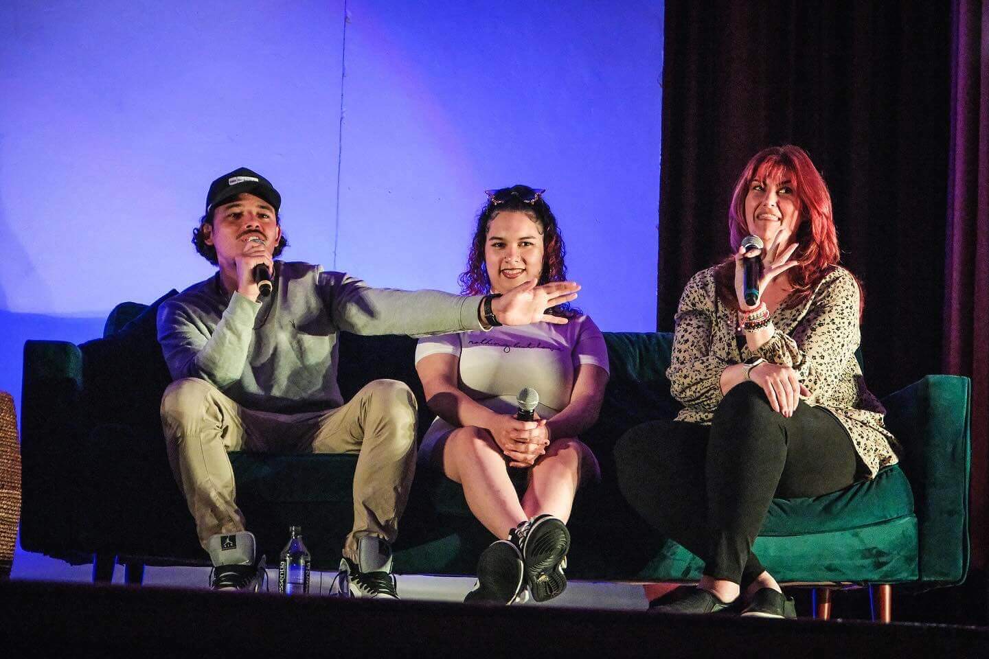 Two speakers on stage, one holding a proclamation, the other speaking into a microphone.