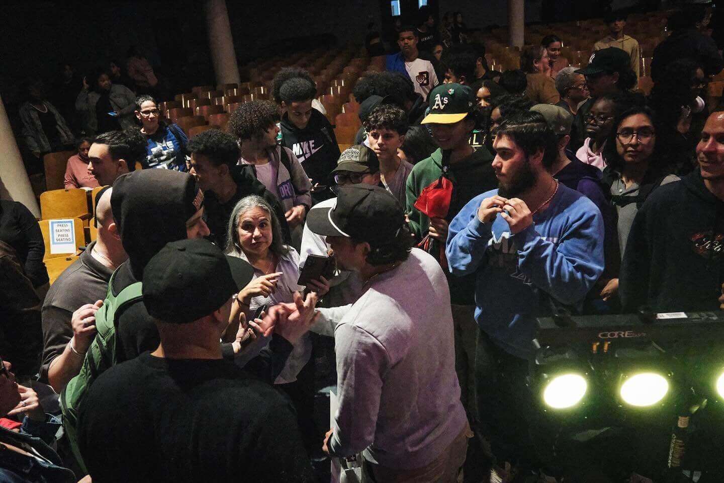 A group of six people poses for a photo with the actor Anthony Ramos.