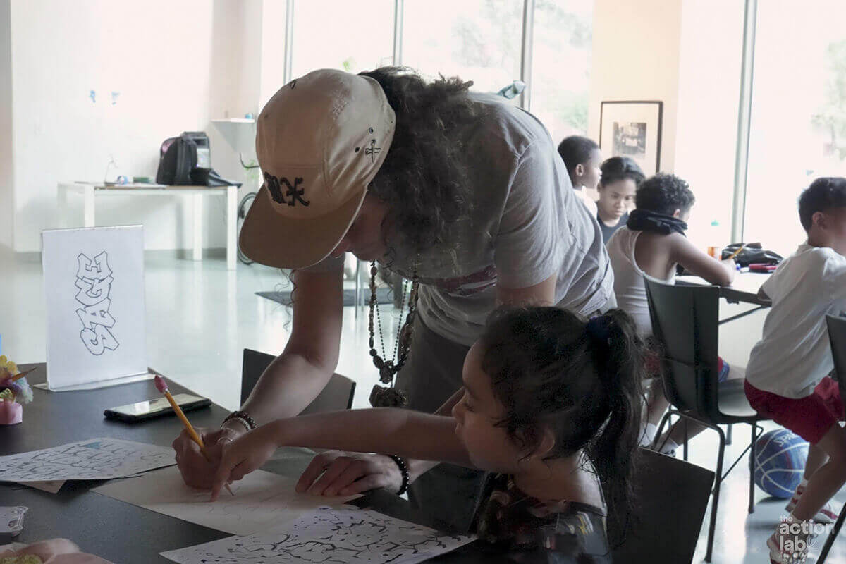 Children engaged in a drawing activity at a workshop.