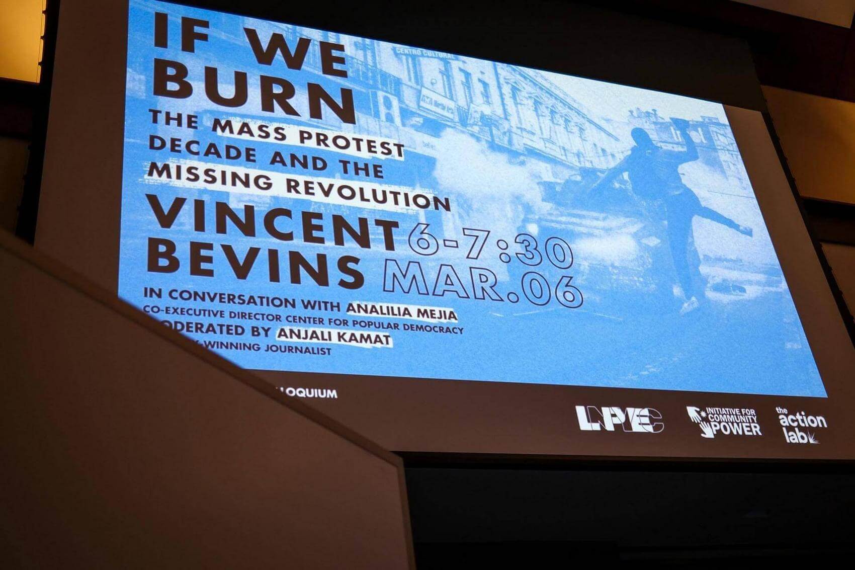 A group of people sitting in a conference room attentively listening to a presentation.