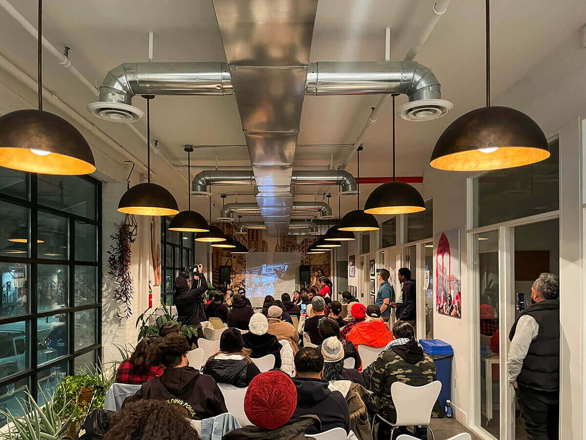 Audience watching a presentation in a gathering.