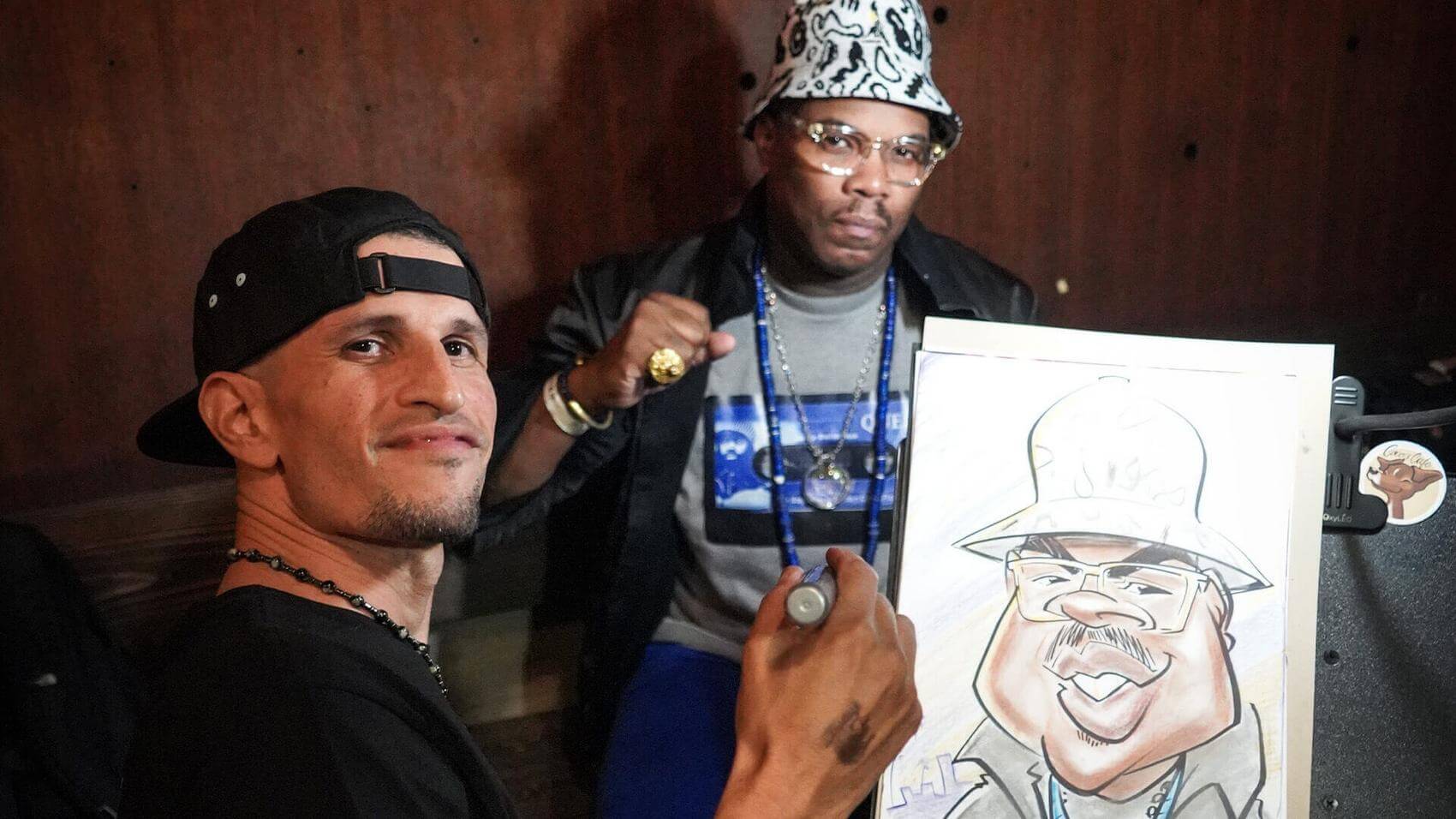 Singer performing on stage with a microphone, audience raising fists in support.