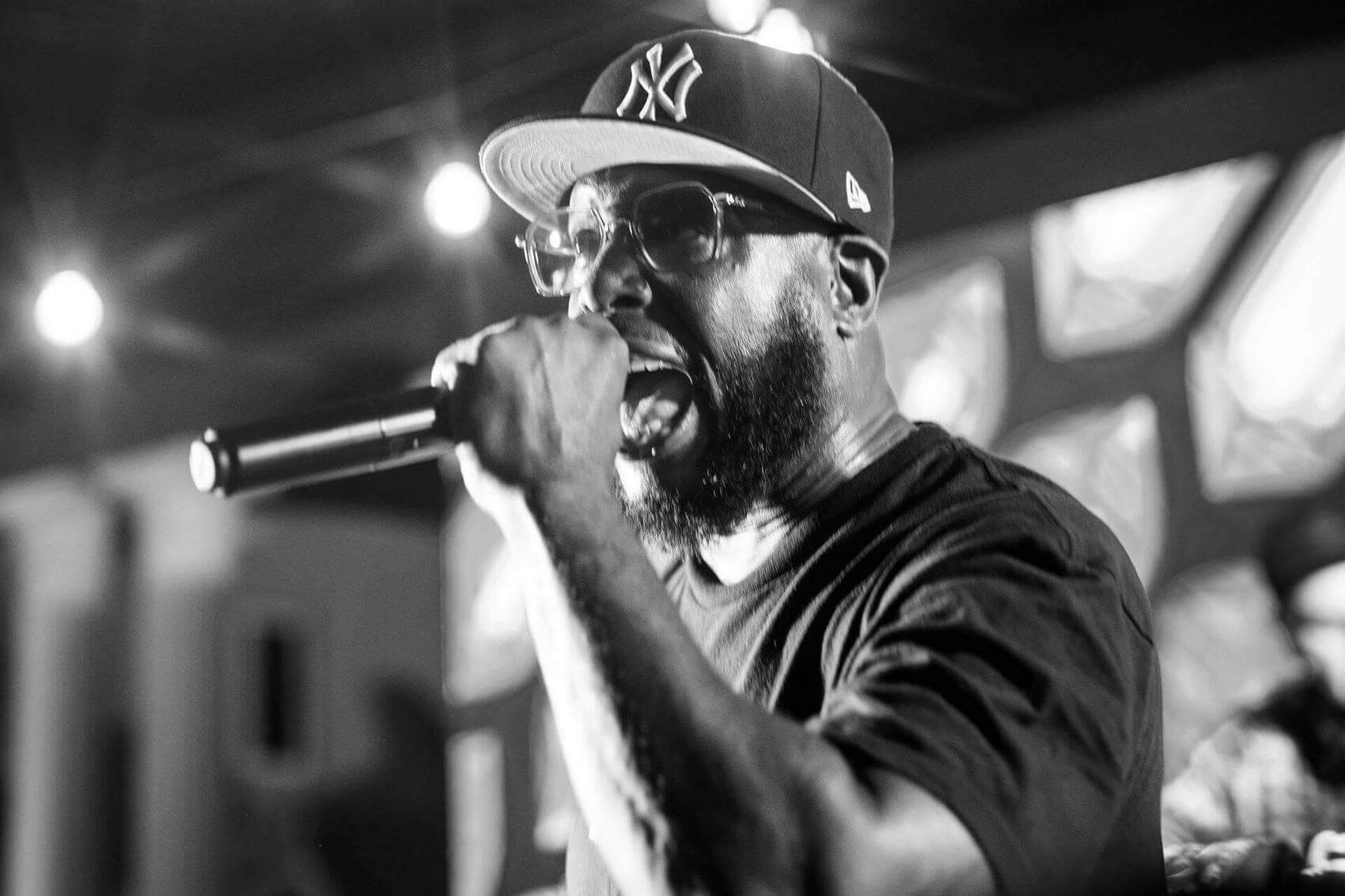 Group celebrating while holding artwork at a gathering.