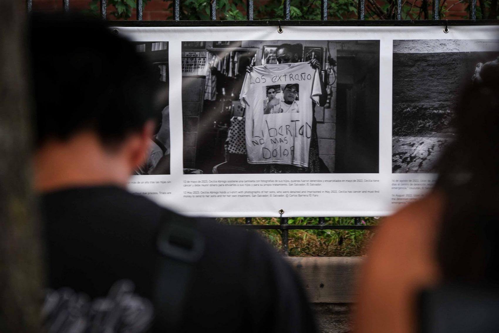 Musicians play percussion instruments on the street, with one man focused on a conga drum.