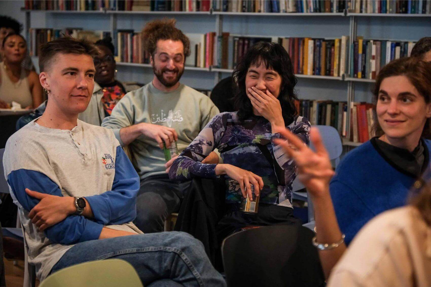 A woman smiling and engaged in conversation with a man.