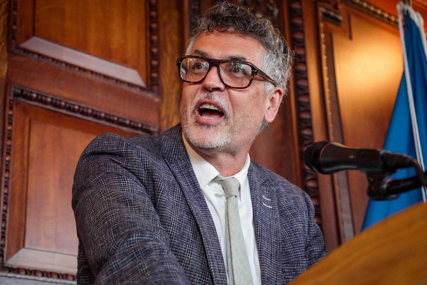 People holding signs at a housing rally, advocating for fair housing policies.