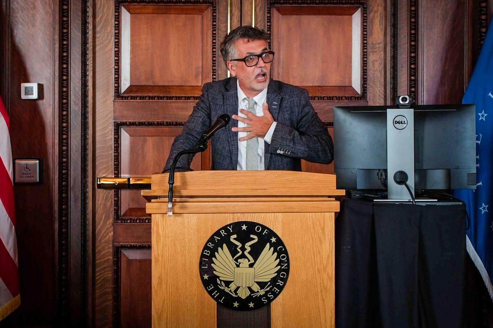Group of people holding signs supporting the Homes Act, with some clapping and smiling.