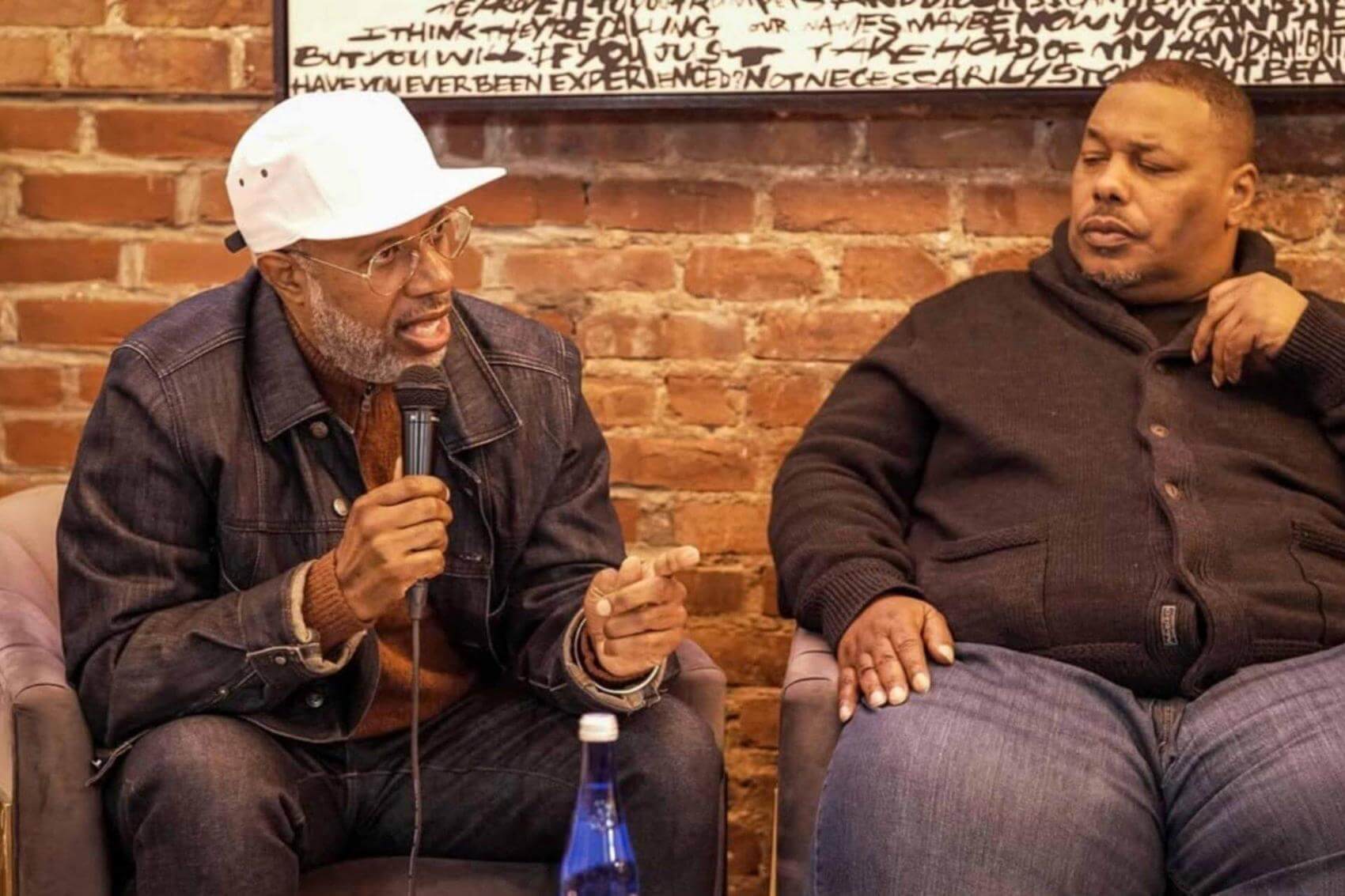 Discussion group with several people; one man speaking while others listen attentively.