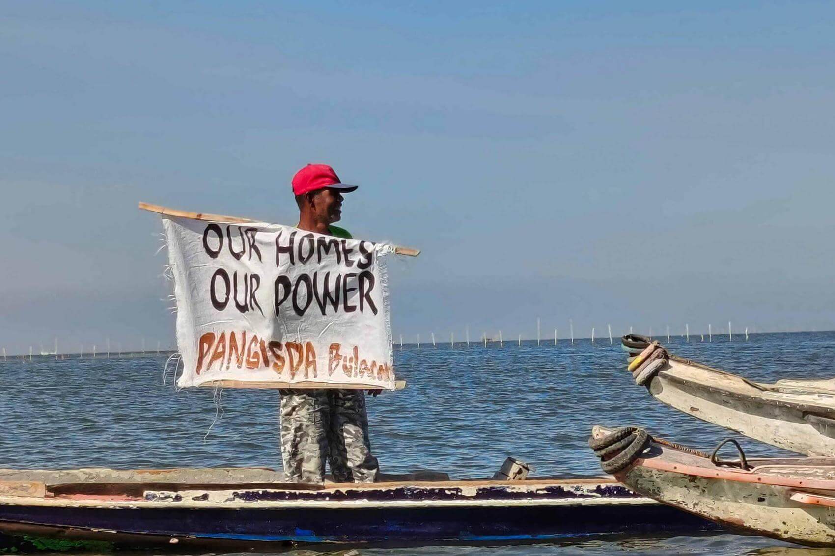 Protesters holding banners and signs advocating for housing rights.