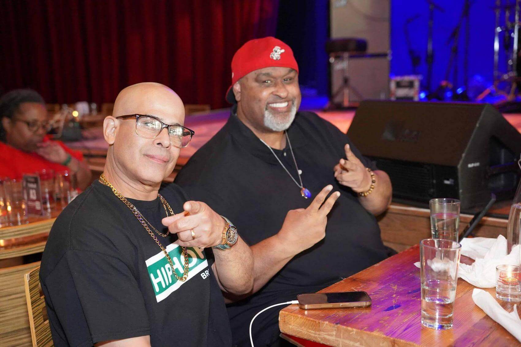 Performers singing on stage with a backdrop reading "FREEDOM Trap."