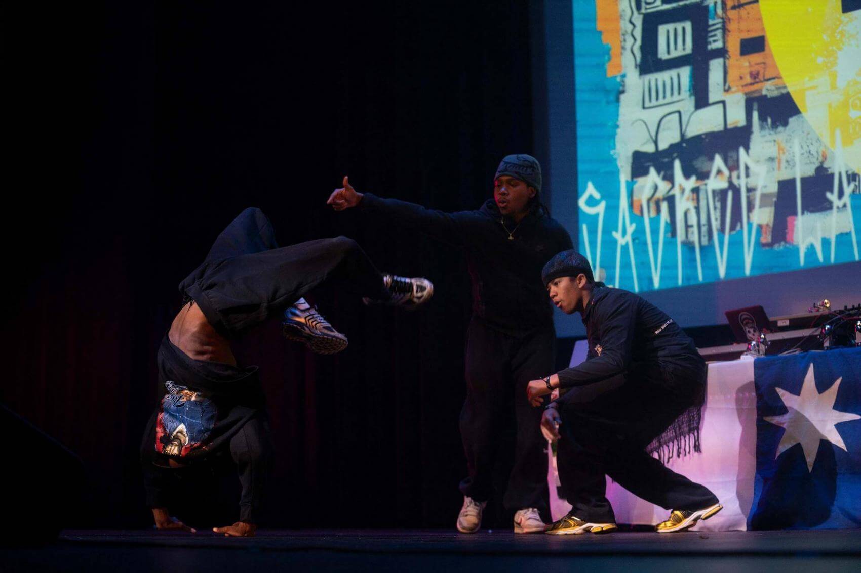 Performer singing with raised fist on stage
