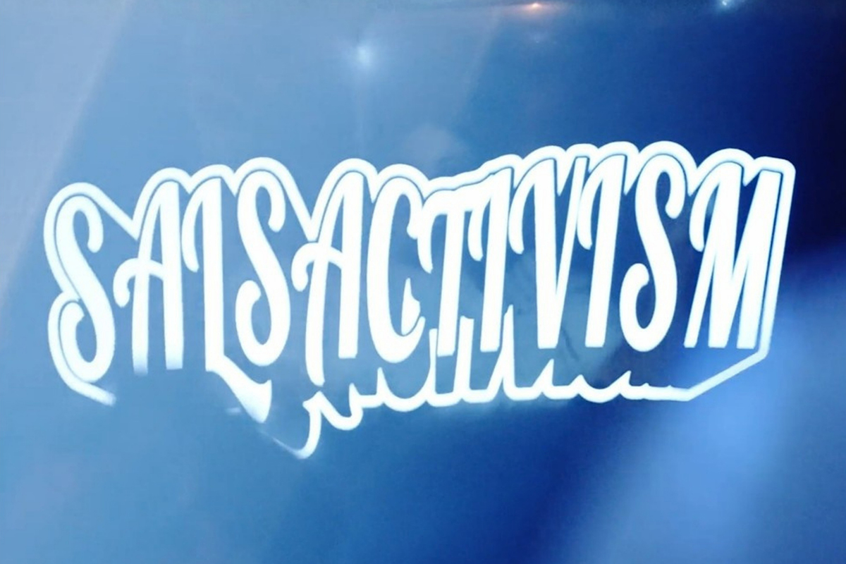 Community members dancing and gathering at SALSACTIVISM event in Astoria featuring live music, DJ sets, and speakers.