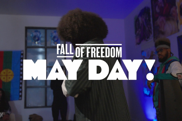 Open mic performance during a May Day gathering in Los Sures featuring poetry, live performance, and community organizing.