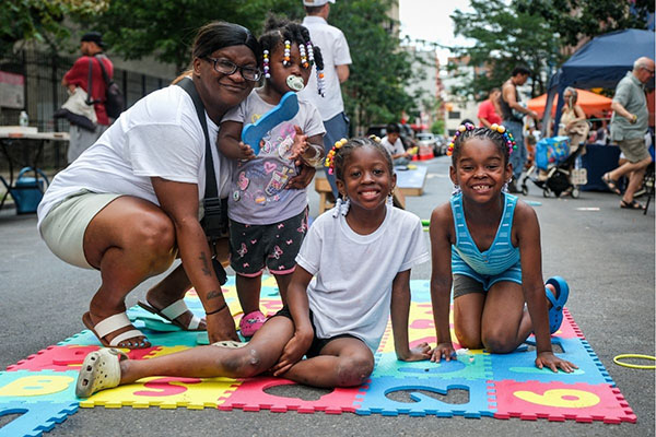 Liberation Summer 2026 campaign artwork featuring a raised fist and event branding promoting community cultural programming across Queens, Brooklyn, the Bronx, and Manhattan.