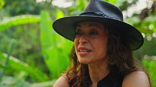 Caridad de La Luz, known as La Bruja, speaking outdoors.