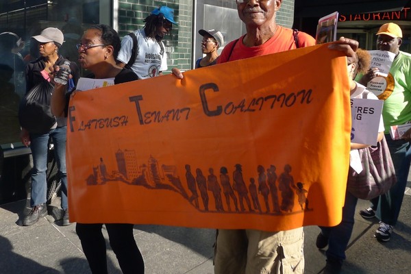 Flatbush Tenant Coalition members holding their banner.