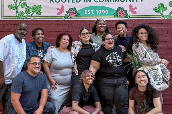 Sixth Street Community Center members gathered beneath their CSA sign.