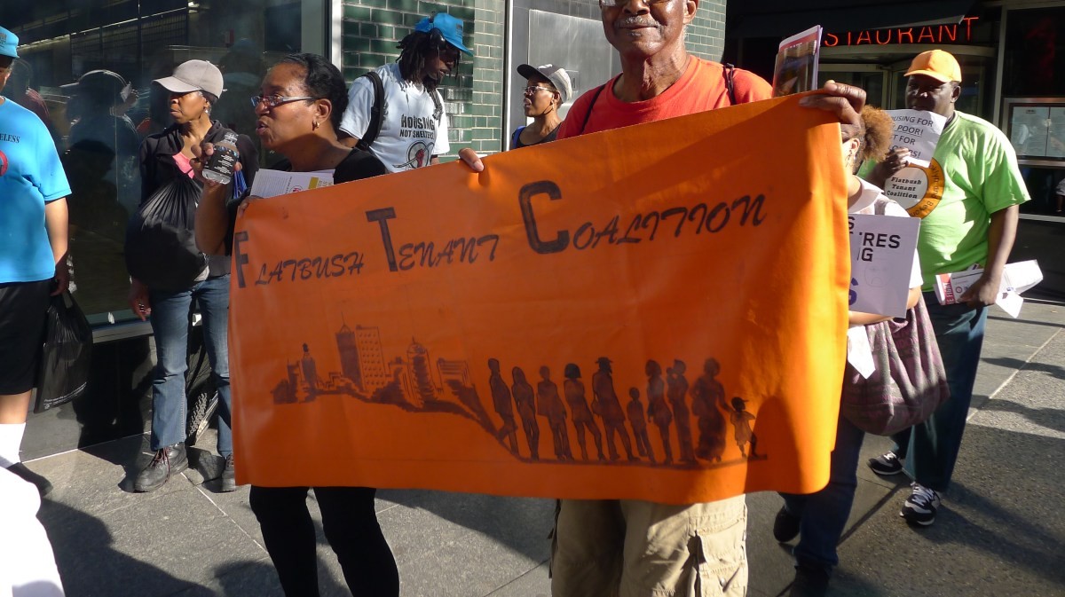 Flatbush Tenant Coalition members holding their banner.